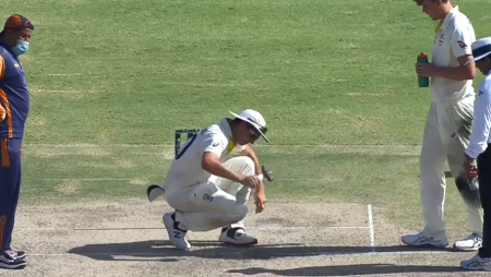 Aus vs Pak: Pat Cummins uses a hammer to try to level an uneven area of the Karachi pitch.
