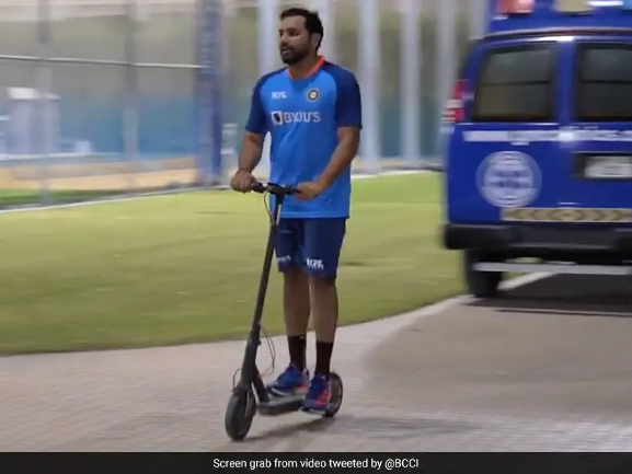 After practice, Rohit Sharma rides his kick scooter.